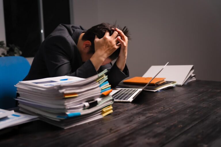 Stressed-young-asian-man-formal-suit